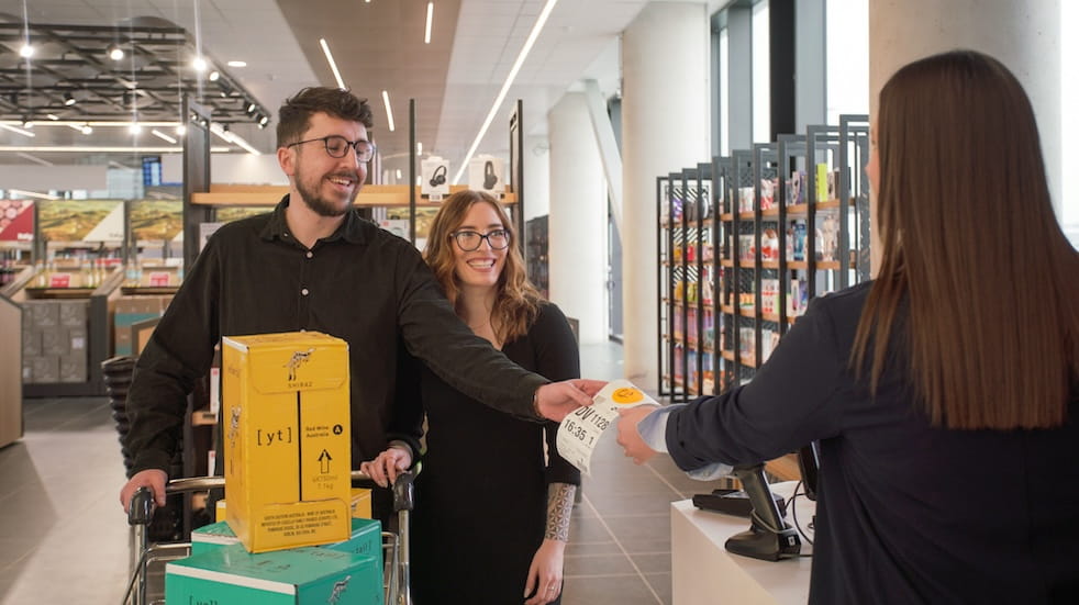 Young couple buying wine in duty free